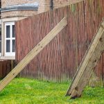 Temporary fix of a damaged wooden fence with wooden props